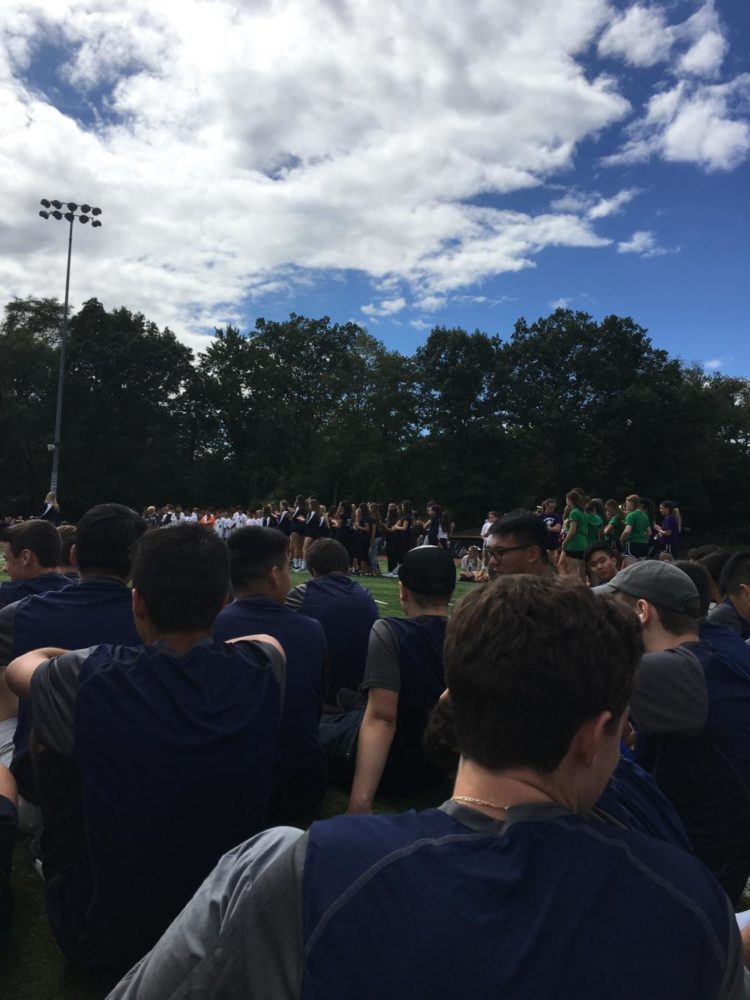 The boys cross country team watches the pep rally activities.