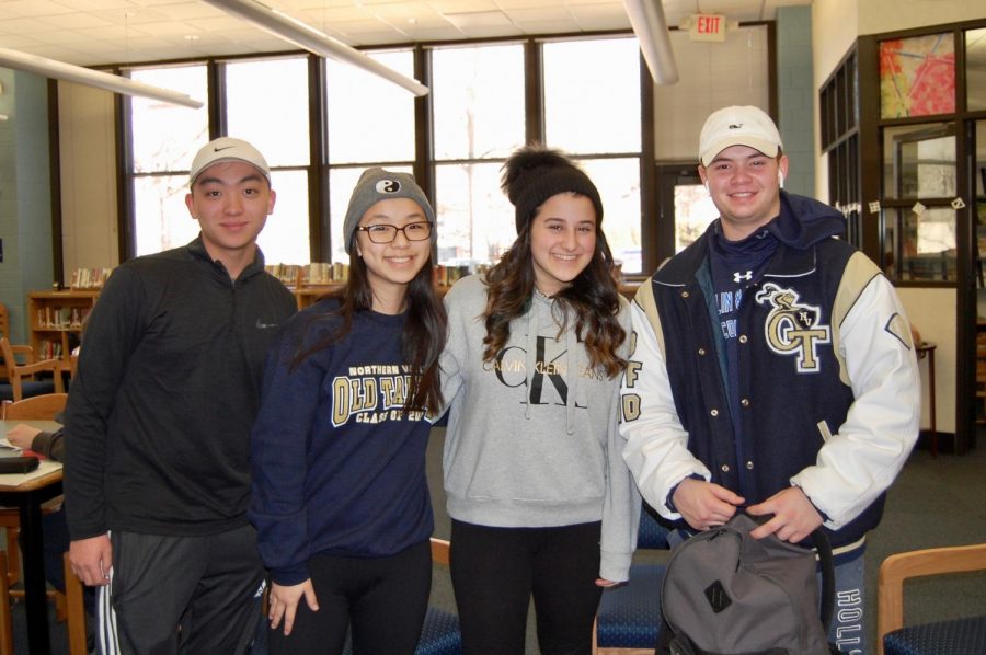 Sophomores Matthias Choi, Ariana Lim, and Ava Petrilli, and Junior John Madaio, during Hat Day in the Media Center.