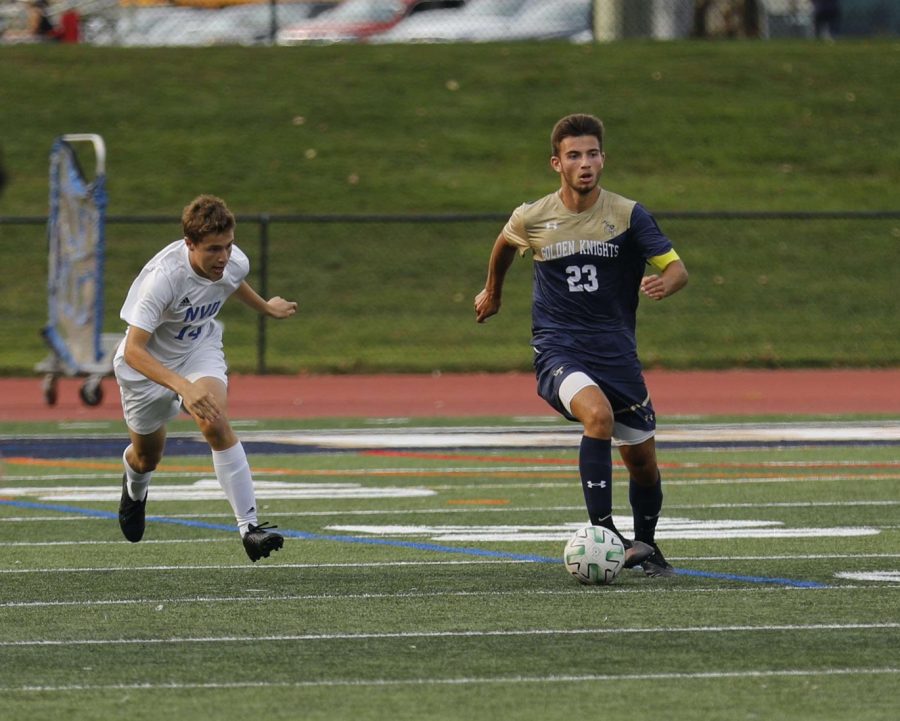 Caunedo dribbles the ball up the field.