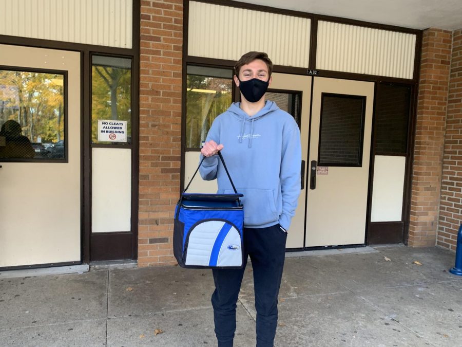 Senior Tyler DeGrandpre feeling cool with a cooler for Anything-but-a-Backpack-Day
