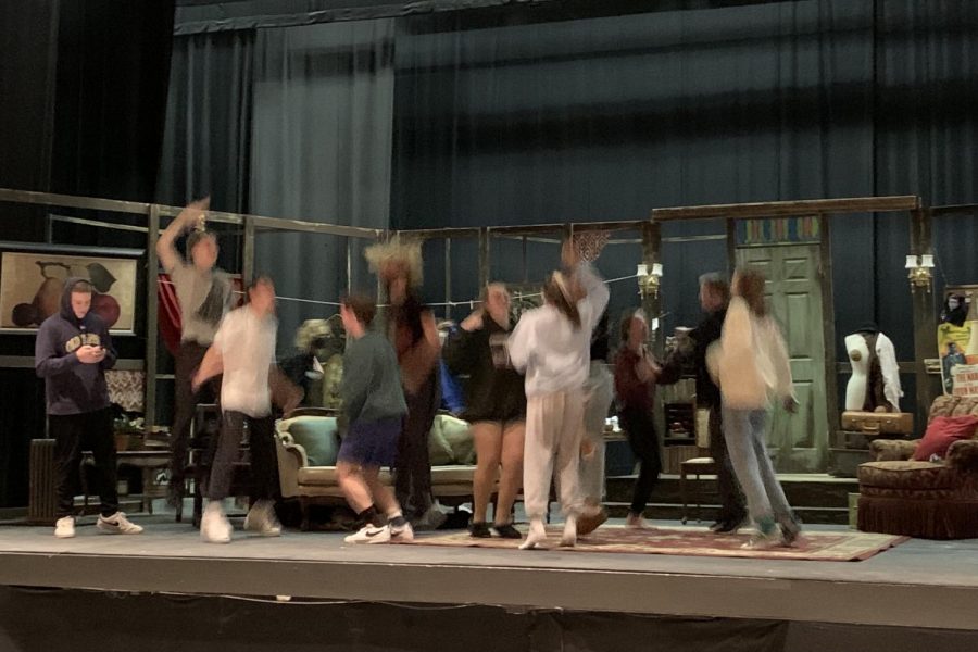 The cast celebrates after completing their first dress rehearsal.
