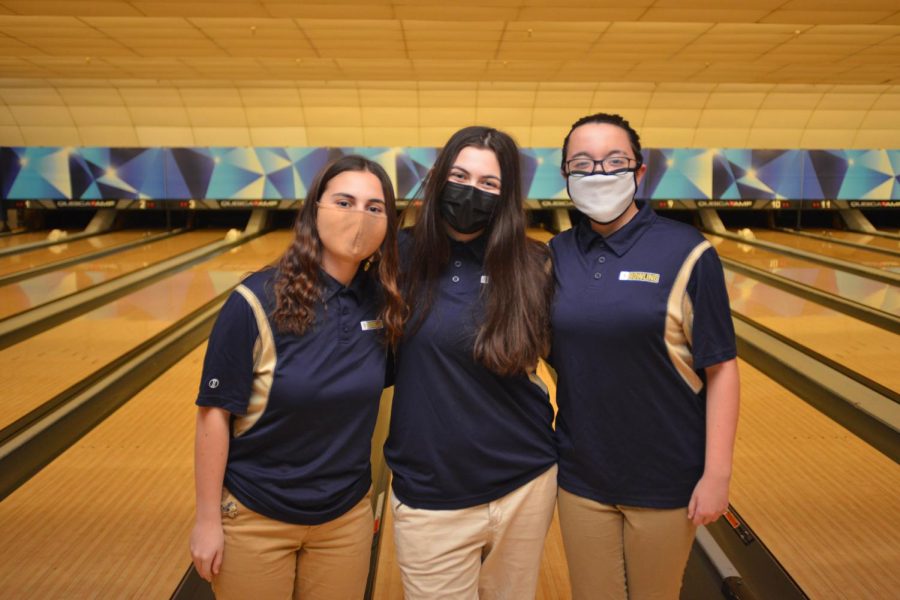 Members of the girls bowling team in front of the lanes. 