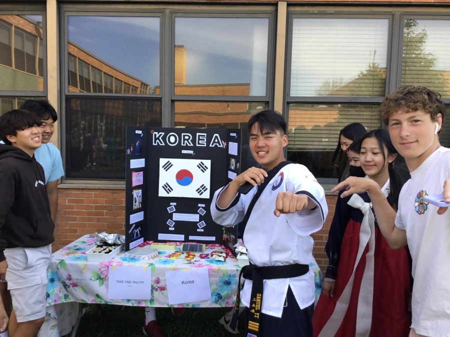 Senior Sam Yi poses in front of the South Korea stand in his Gi.