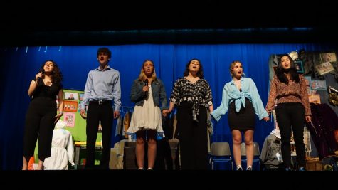 Seniors perform a medley of songs from the four musicals of their high school careers.