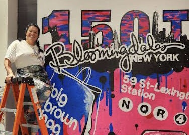 Donna Dolby stands in front of her finished mural.