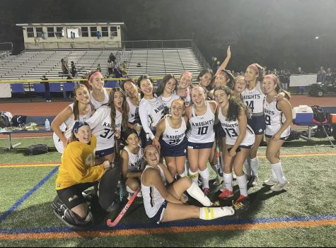 The field hockey team poses for a picture together after a winning their first game of the season.
