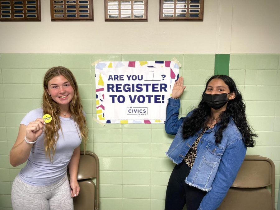 Juniors Caroline Tharakan and Lizzie Ognibene run the voter registration booth at lunch. 