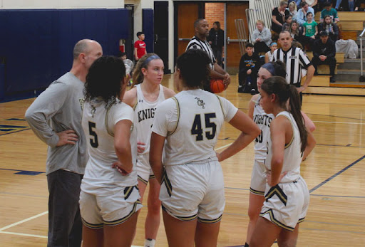 Coach Dunn speaks to players on the girls basketball team.