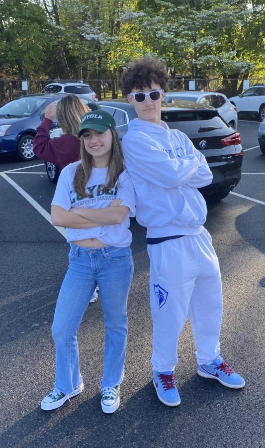 Sofia Viganola and Justin Torres pose side by side in their college merchandise