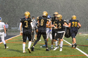 Football celebrates in the rain on Friday against NVD