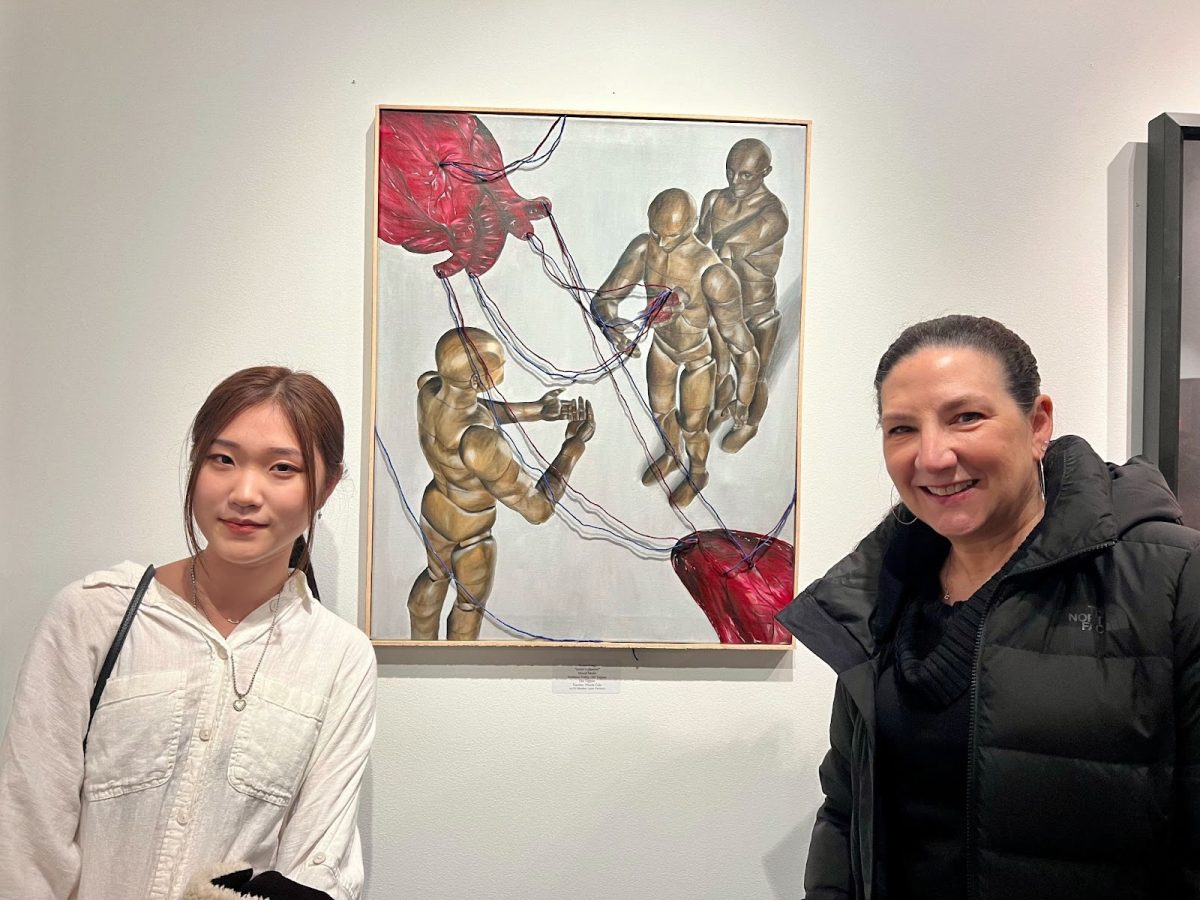 Kimin Kang poses with her artwork featured in the Emerging Artists Gallery.