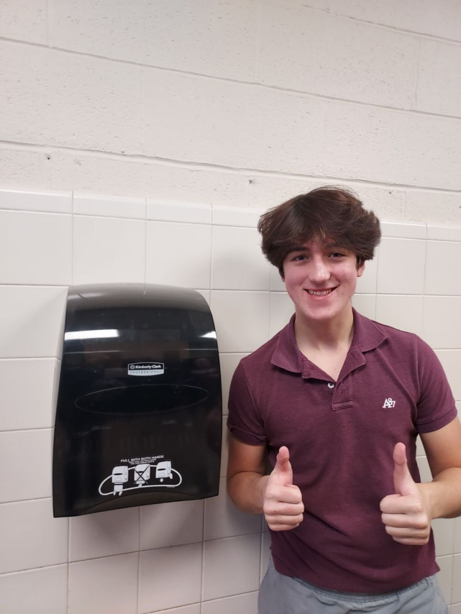 Jake Ellengold poses with the reinstalled paper towels.