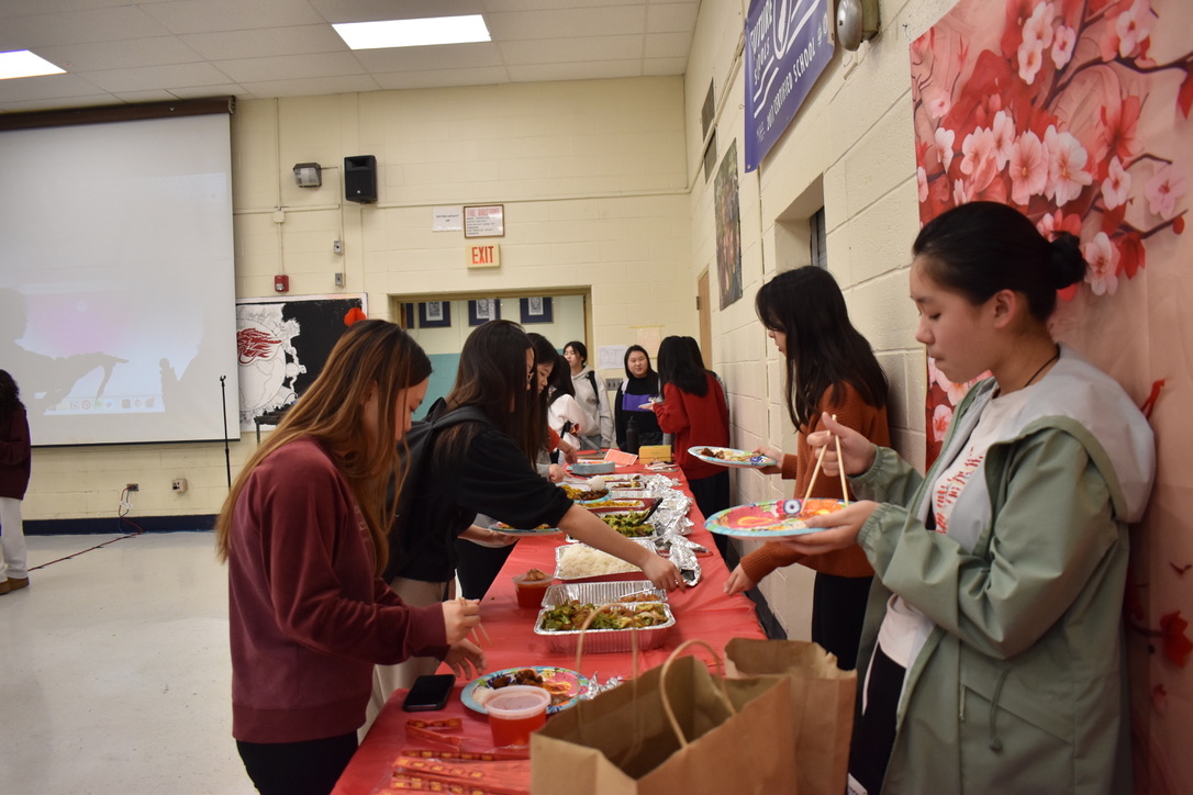 People eating food during the Chinese Clubs Lunar New Year Celebration