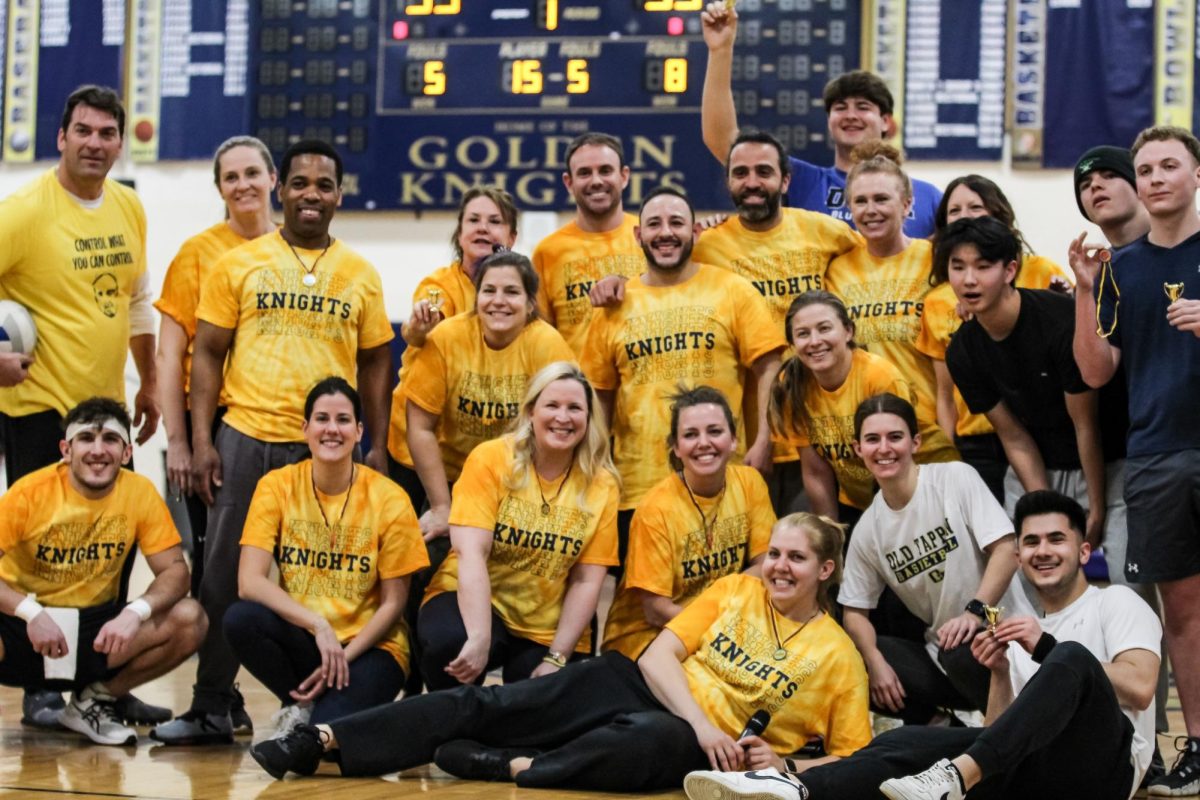 Participants in the students versus staff volleyball game pose together. 