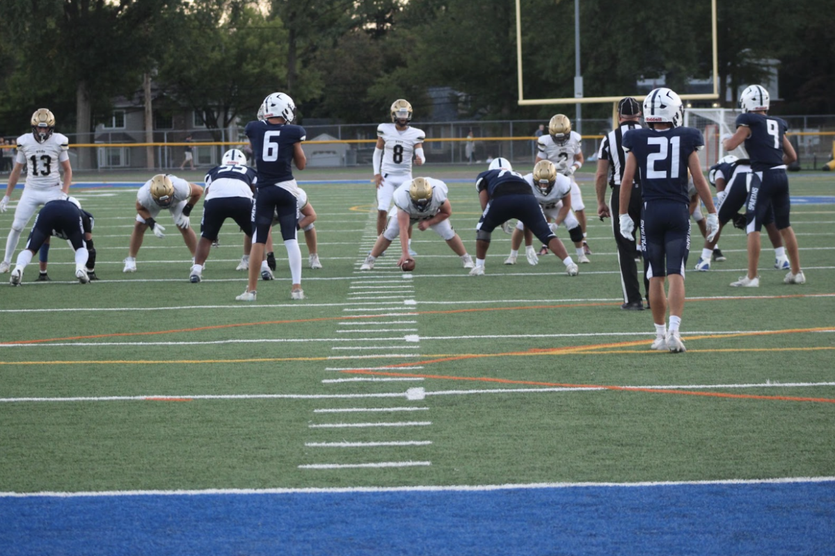 Zach Miceli (#8) takes the snap
