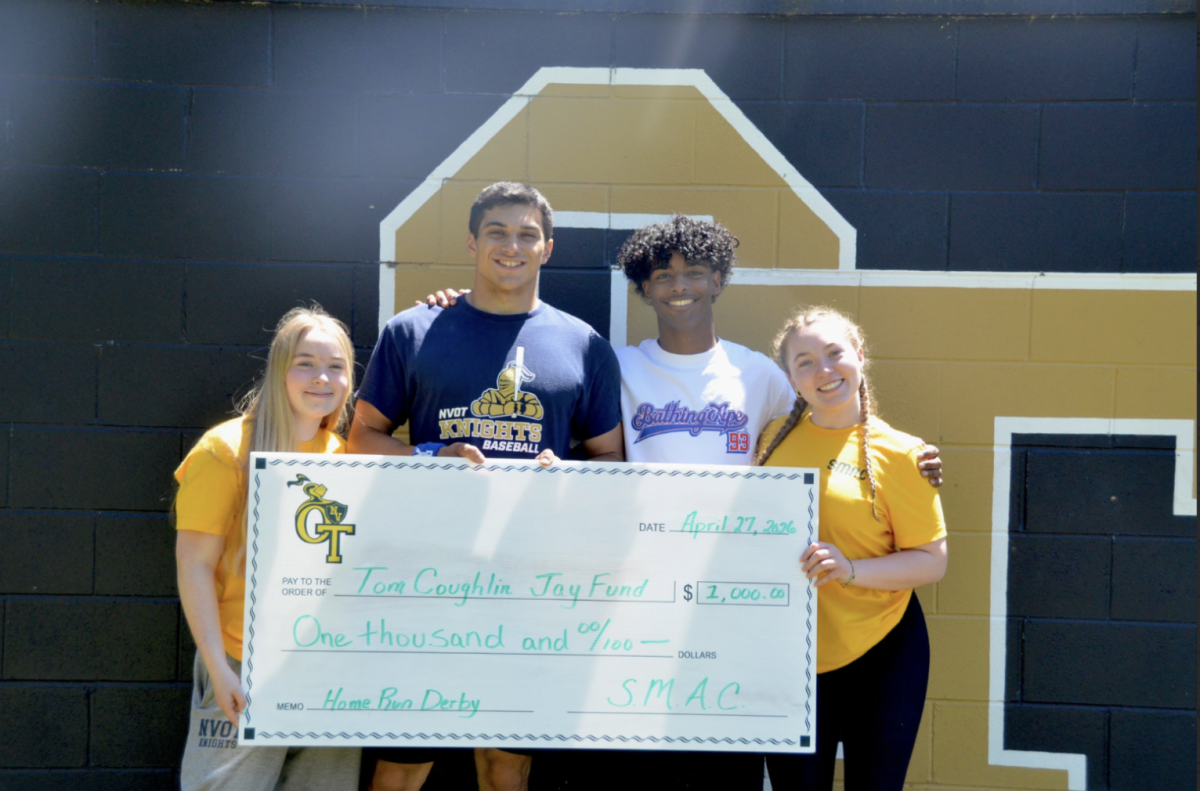 From left to right: Megan Collins, Anthony Onnembo, Derek Antigua, and Erin Collins holding the donation check for the Jay fund
